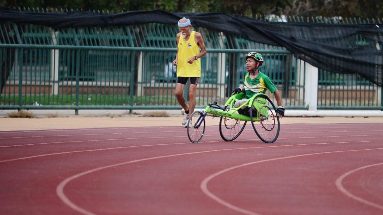 man using green wheelchair for walking