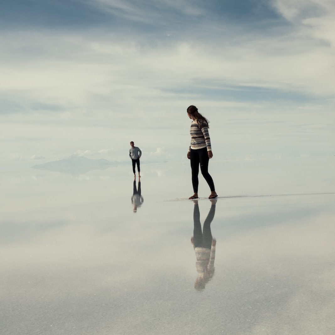 man and woman walking on clouds