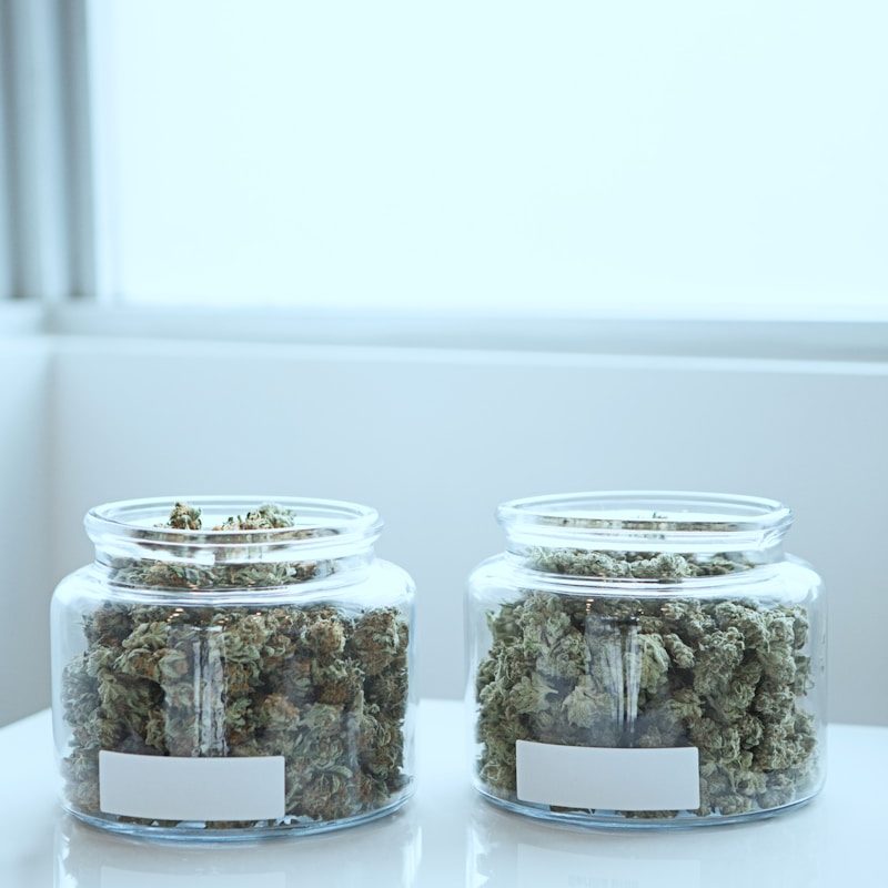 full of kush in clear glass jars on table