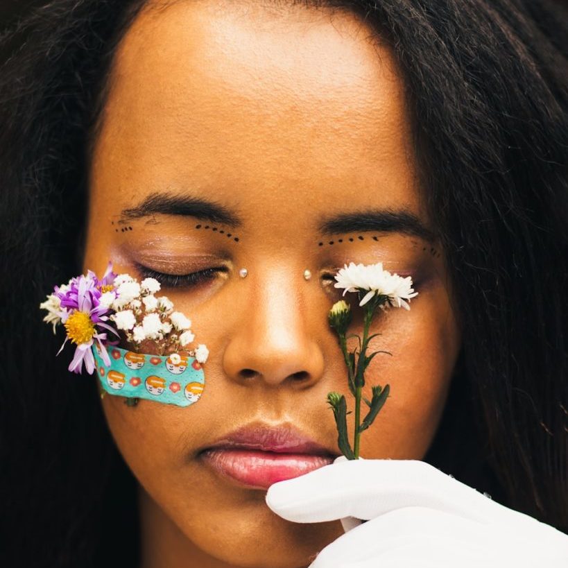 a woman with flowers painted on her face