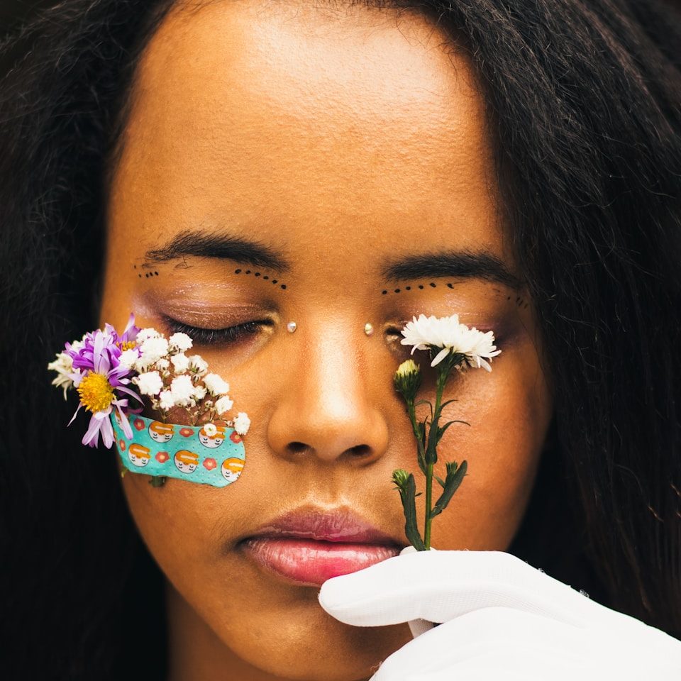 a woman with flowers painted on her face