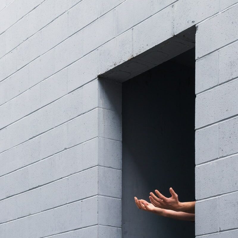 person standing on gray concrete wall